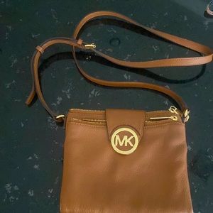 Michael Kors leather crossbody purse. Lots of storage .